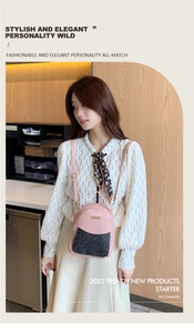 Pink PU leather mini backpack with black sequin pocket detail and gold zippers on a model