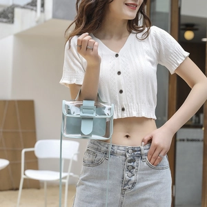 Light blue transparent PVC crossbody mini bag with inner pouch worn by a model