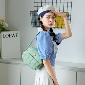 Chic mint green quilted shoulder bag for women with elegant golden circular logo