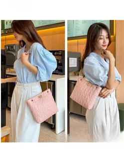 Detail of pink quilted shoulder bag with gold chain strap and elegant turn-lock closure