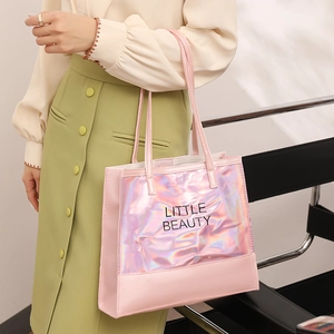 Pink holographic laser tote bag with Little Beauty text shown on model in stylish outfit