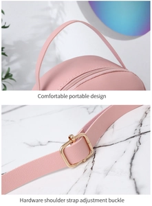 Detailed view of pink backpack featuring high-quality leather handles and golden metal buckles