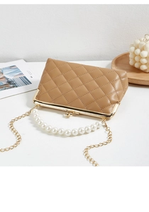 Detailed view of khaki quilted bag featuring pearl handle and golden kiss lock closure
