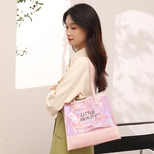 Fashionable laser pink tote bag for women with Little Beauty text shown on model shoulder