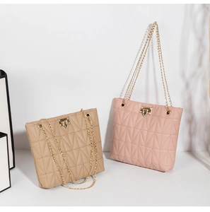 Close-up of geometric quilted chain bags in beige and pink with gold square twist locks