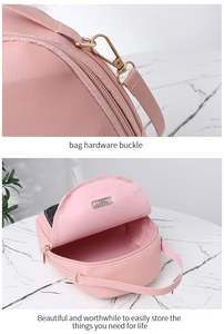 Detail of golden hardware buckle and spacious interior of pink PU leather bag