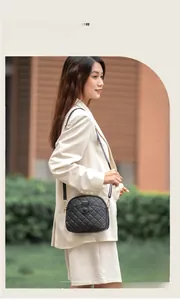 Close-up of black quilted shell crossbody bag with golden metal hooks and zipper