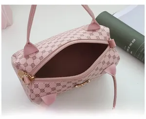 Top view of pink cylindrical handbag showing spacious interior and clover pattern
