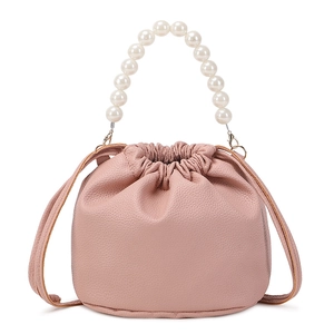 Pink drawstring bucket bag with litchi texture and elegant pearl handle strap