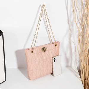 Quilted light pink crossbody bag with gold chain straps and a front metal twist lock