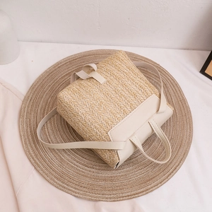 Handwoven straw backpack for women with beige PU leather straps and minimalist design