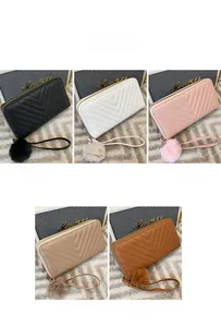 Women's quilted wallets in black, white, pink, khaki, and brown with fluffy pompom charms