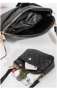 Interior layout and storage capacity of black quilted crossbody shell bag