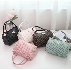 Five assorted Boston handbags with circle prints and butterfly charms in various colors