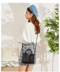 Chic black litchi texture mini handbag styled with a crossbody strap and top handle