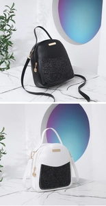 Detail view of mini sequin backpacks in black and white with gold zipper accents