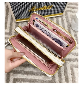 Detailed interior of a white double zipper wallet showing pink card slots and phone pocket