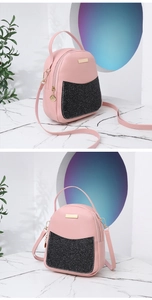 Detail view of pink PU leather mini backpack with black glitter pocket and gold hardware