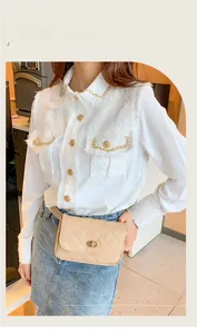 Close-up of beige quilted waist bag with gold twist lock on stylish denim and tweed outfit