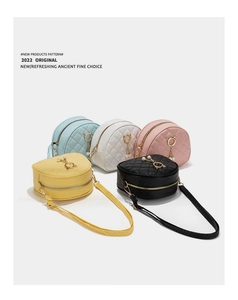 Detailed view of quilted cross-body bags with pearl cat charms in five vibrant colors