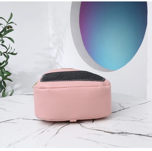 Detailed side view of pink and black glitter backpack on marble background