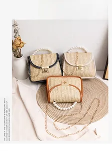 Detailed macro view of pearl-handled straw bags in black, beige and brown tones