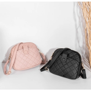 Detail of pink and black shell bags with quilted texture and gold zipper closures
