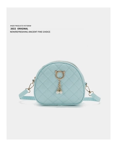 Detail of light blue semi-circle crossbody bag with cat ear metal and pearl tassel decor