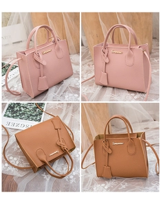 Detail showing litchi grain texture on pink and brown leather handbags with metal logos