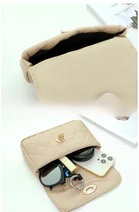 Interior detail of quilted waist bag showing storage for phone, lipstick and sunglasses