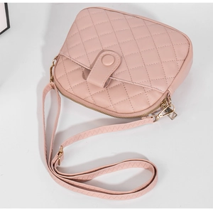 Top-down view of a pink shell-shaped bag featuring quilted patterns and golden hardware