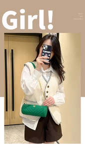 Detail of green cylindrical crossbody bag with V-shaped quilting and gold chain strap