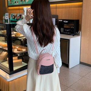 Mini pink leather backpack for women with sparkling black sequin front pocket detail