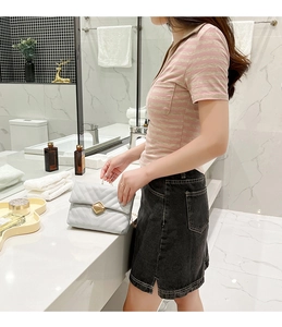 Casual pink and grey striped polo shirt with pockets paired with a side slit denim skirt