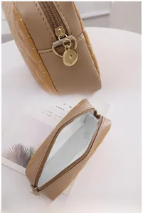 Close-up of camel quilted crossbody bag featuring golden zipper and interior storage view