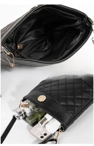 Detail view of black quilted crossbody bag showing interior capacity for phone and cosmetics