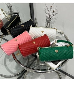 Detail of colorful cylinder bags featuring V-shaped quilting and chain straps
