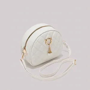 White quilted crossbody bag with cat ear metal ring and hanging pearl charms