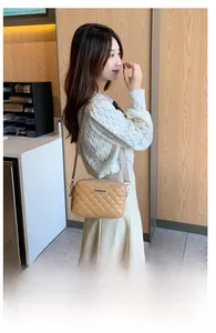 Khaki quilted leather crossbody bag with chain strap shown on a model side view