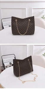 Close-up of brown bucket bag with circular patterns and golden chain strap detail