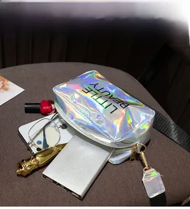 Detailed internal view of holographic crossbody bag storing mobile phone and glasses