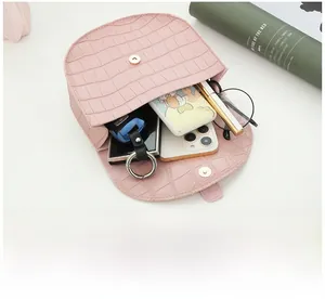 Pink faux crocodile leather saddle bag interior showing storage space for essentials