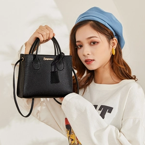 Chic black lychee grain leather handbag with gold logo and detachable crossbody strap