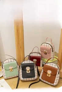 Detailed display of mini plaid backpacks in multiple colors with metallic gold clasps