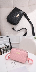 Detail of black and pink crossbody bags with fish scale quilting and gold metal accents