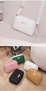 Detail of fish-scale quilted texture and golden hardware on the elegant crossbody bag