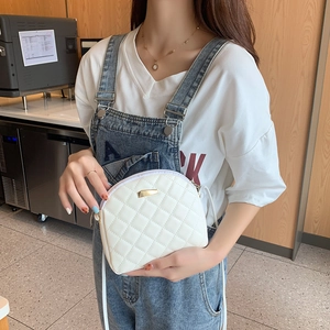 Mini borsa a conchiglia bianca trapuntata con dettaglio in metallo dorato su modella