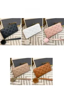 Detailed view of women long wallets with heart embroidery and detachable faux fur pompom