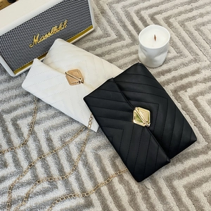 Quilted mini crossbody chain bags in black and white with V-stitch and gold buckle