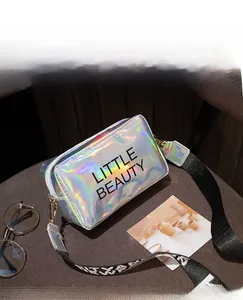Close-up of holographic crossbody bag with Little Beauty text and adjustable strap